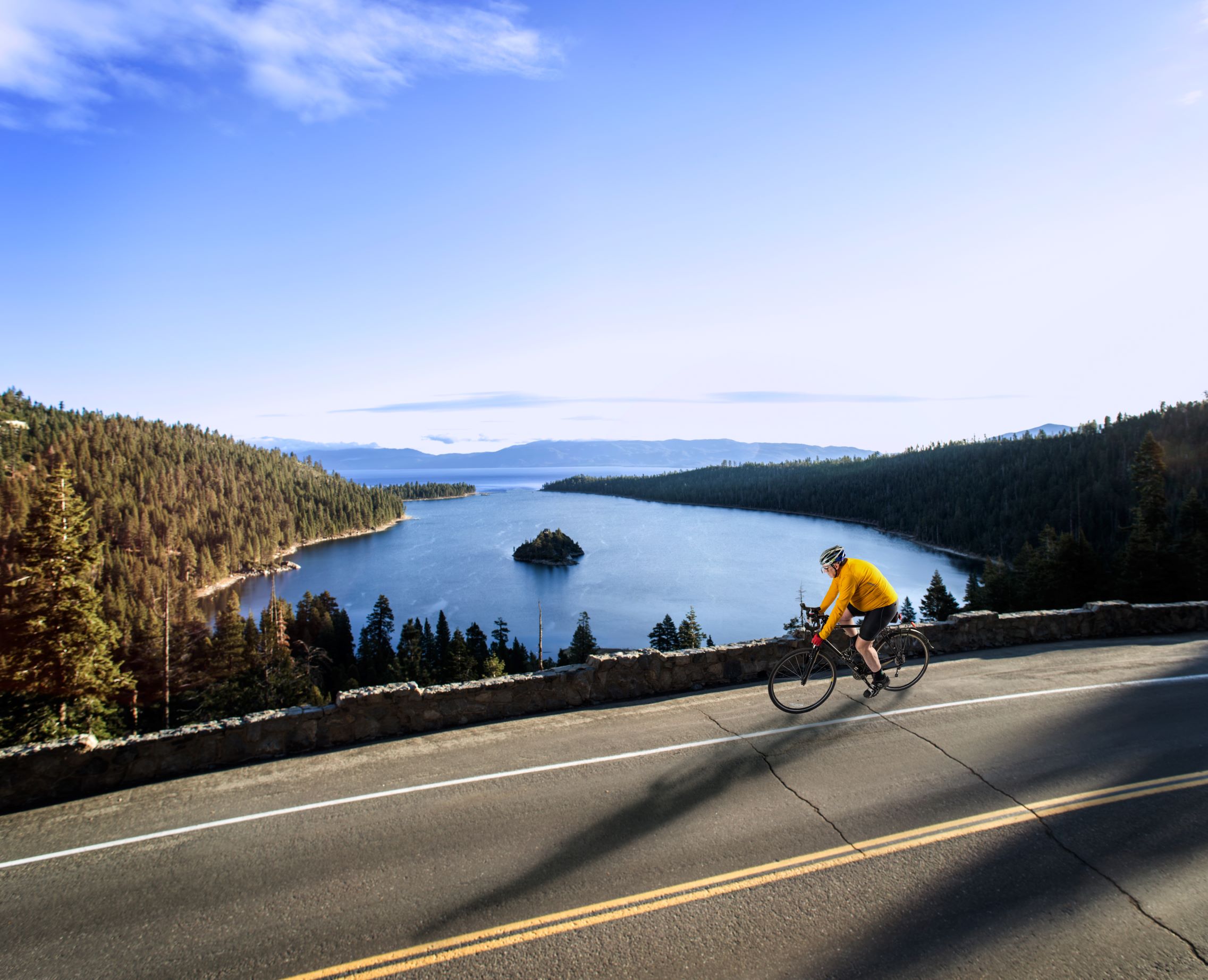 Cyclists riding along a road overlooking Lake Tahoe.